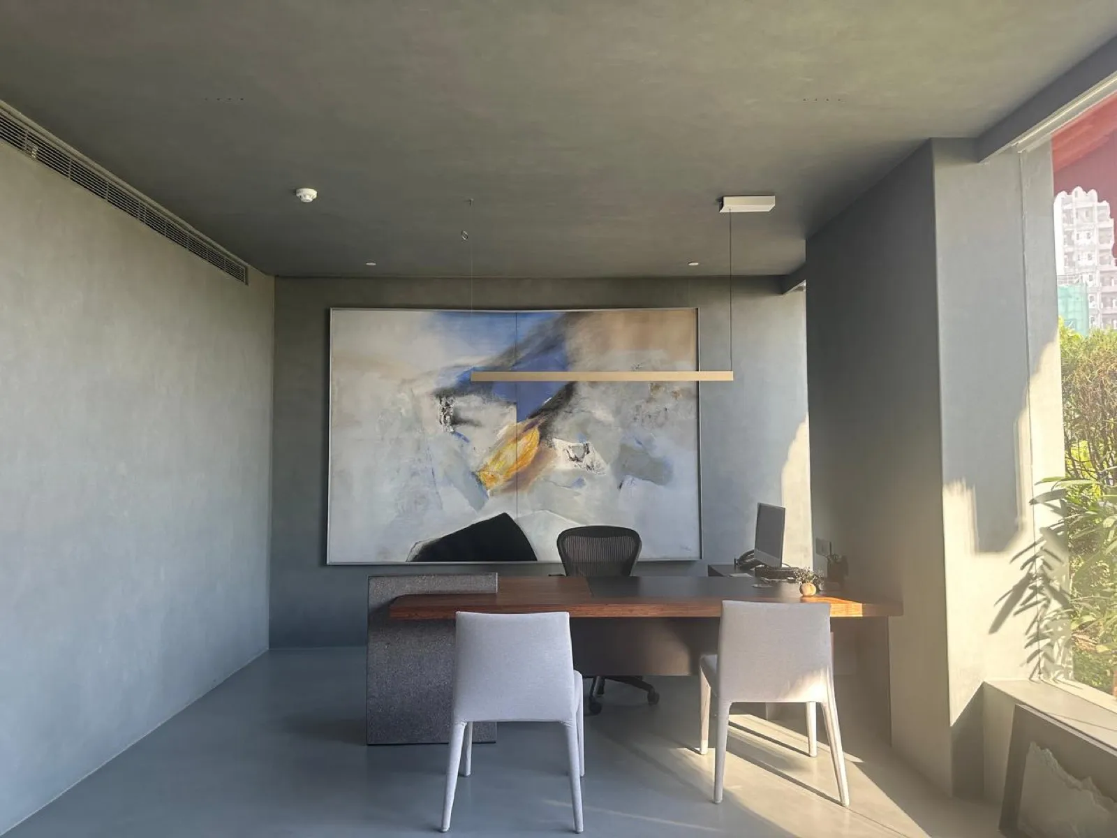 The grey plaster cabin and abstract canvas at the RPG office by Sonia Gehlot