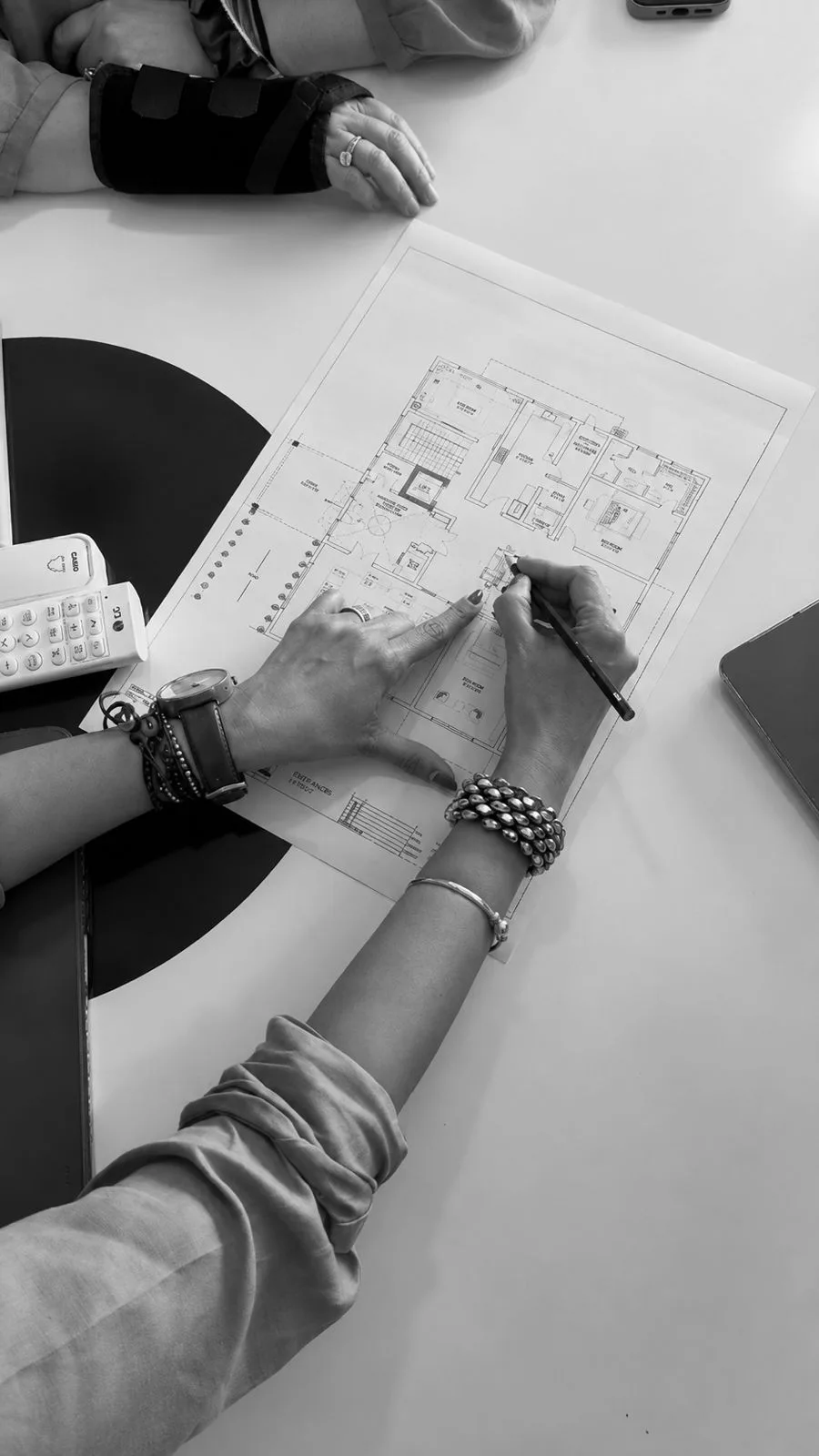 Sonia Gehlot at the drawing board, reviewing a floor plan