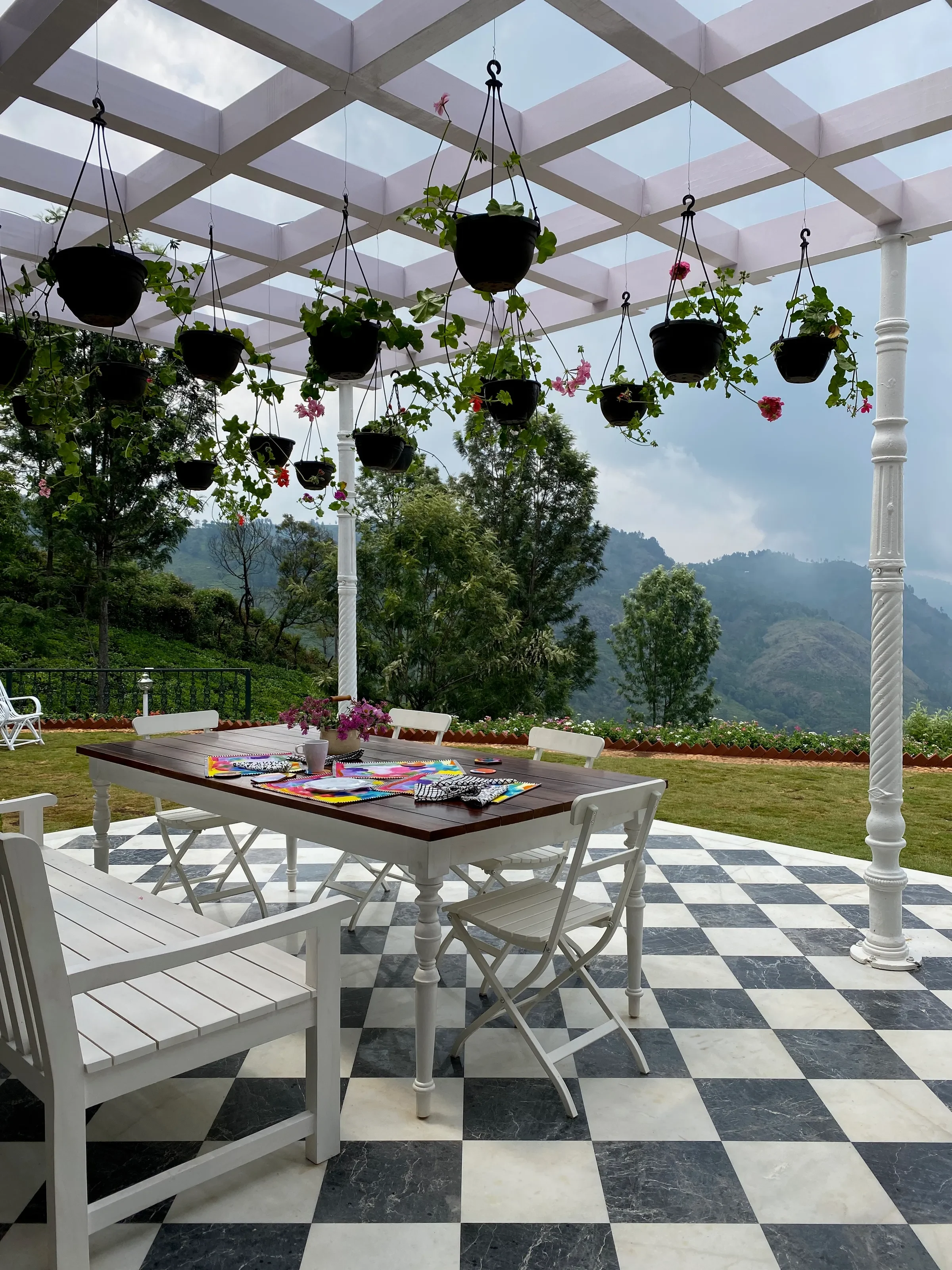 Hanging baskets over the pergola table at the Coonoor bungalow