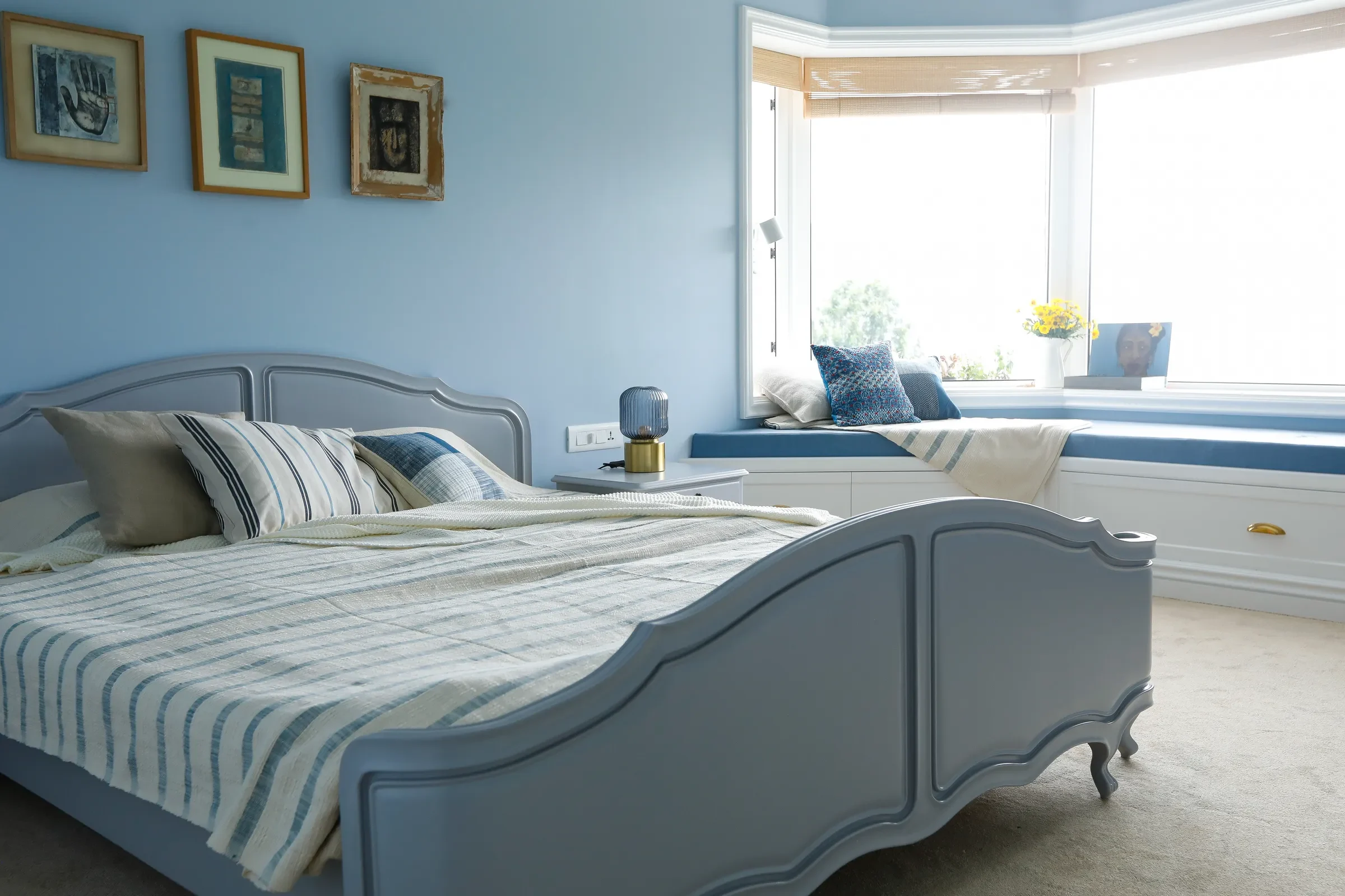 The blue guest bedroom with a bay window seat