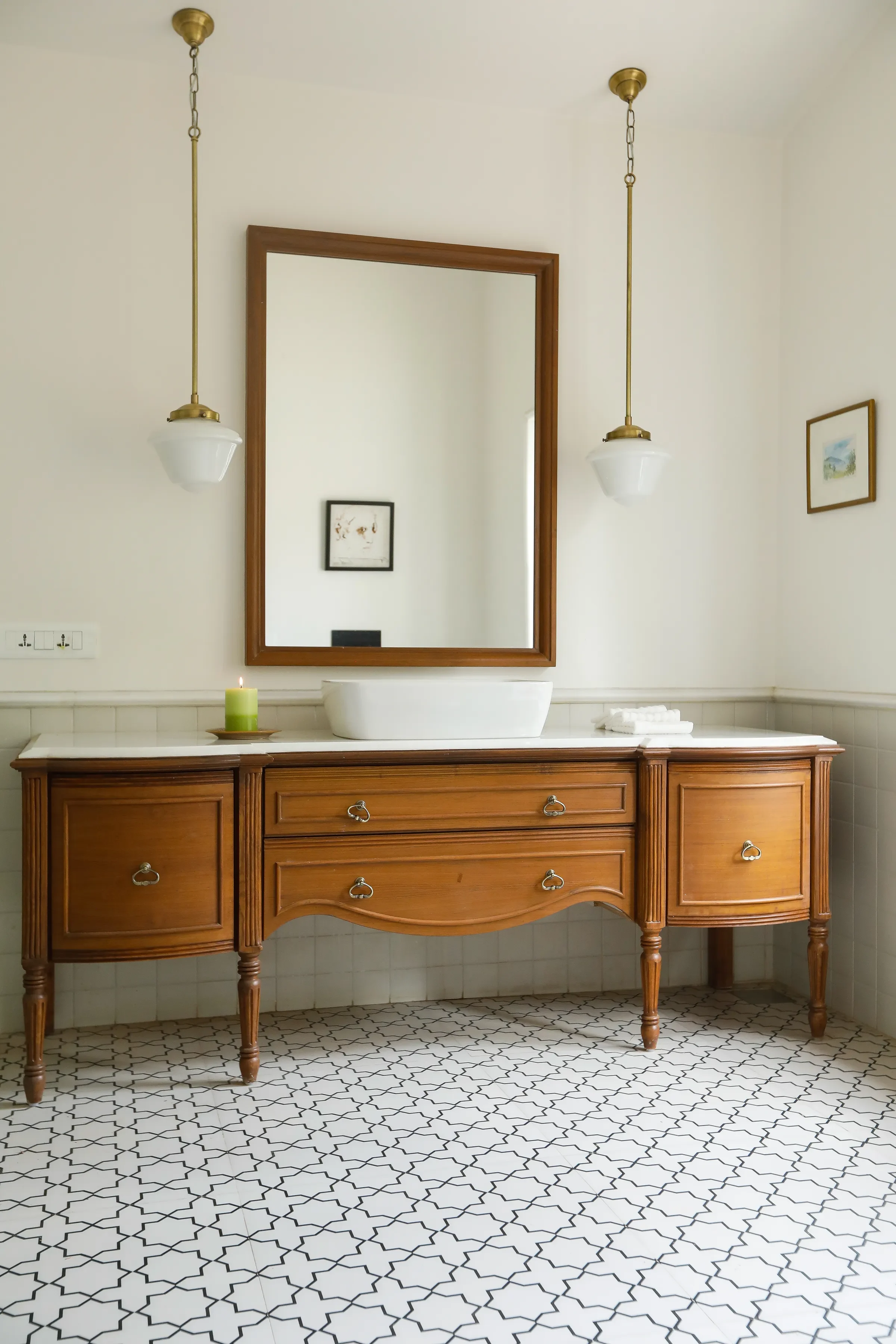 A wooden vanity between two pendant lights