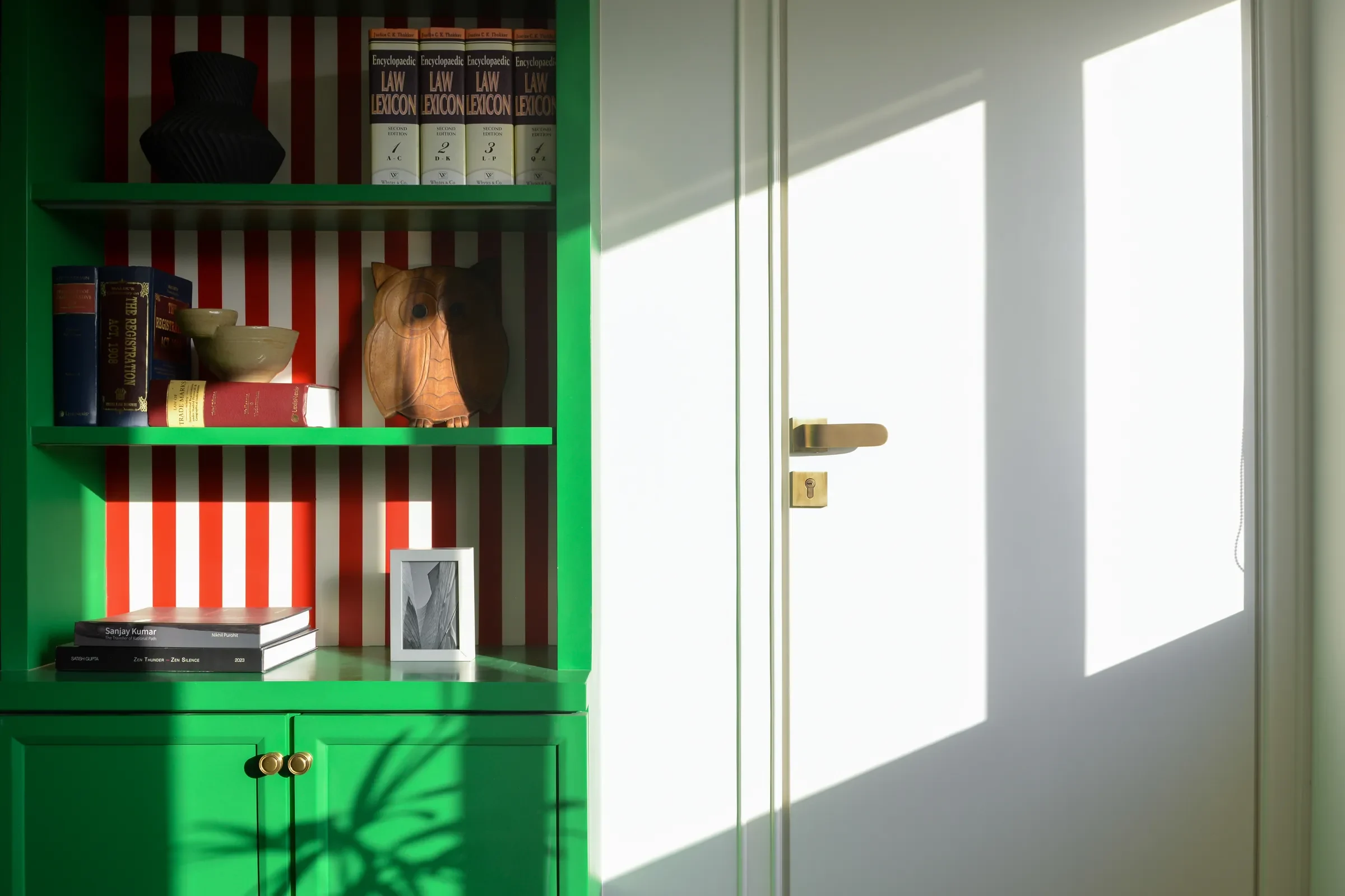 Red and white stripes behind the green cabinet doors