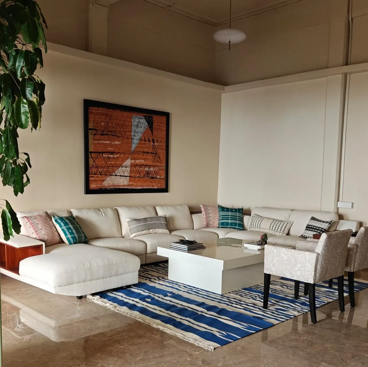 The living room at Tranquila, a white sectional on an indigo dhurrie