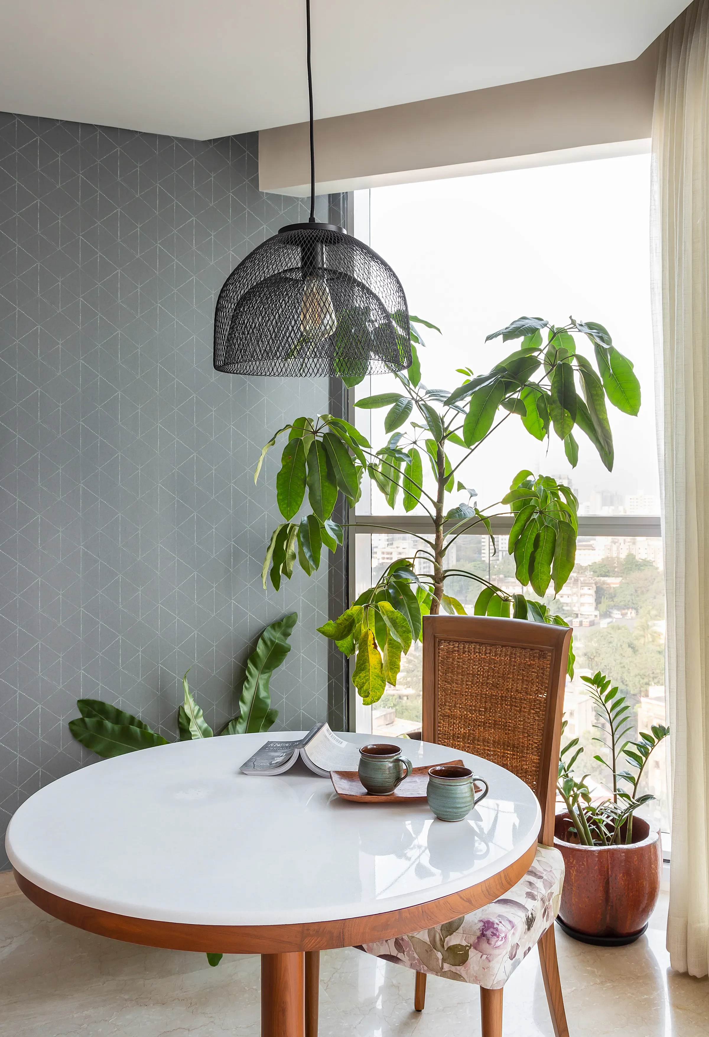 The round table on the planted balcony of the mid-century apartment