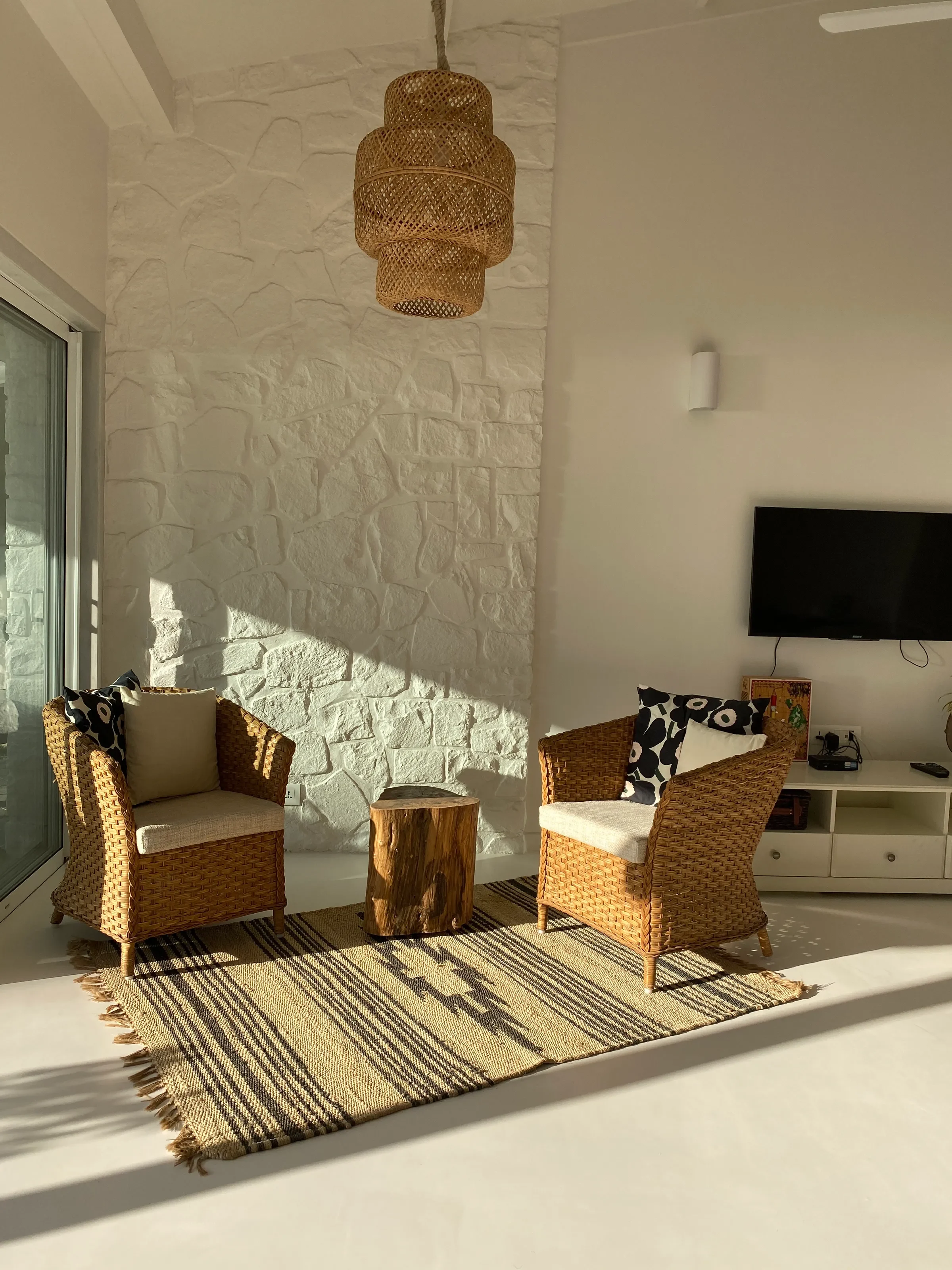 Cane armchairs on the terrace at the Marve beach house