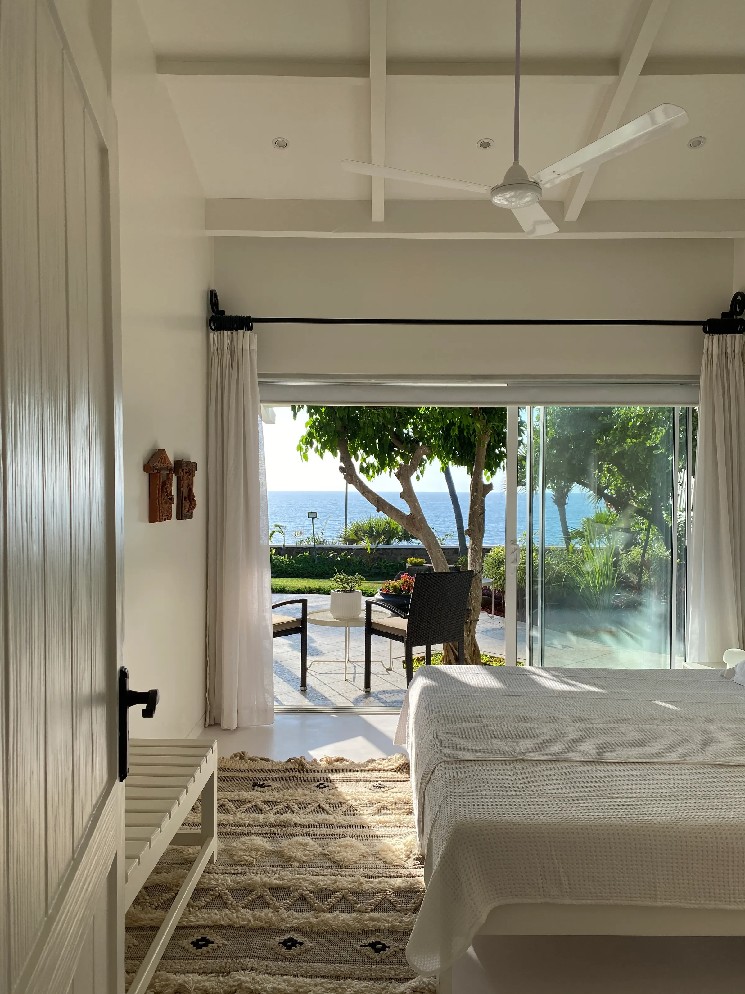 A bedroom door open to the garden at the Marve beach house