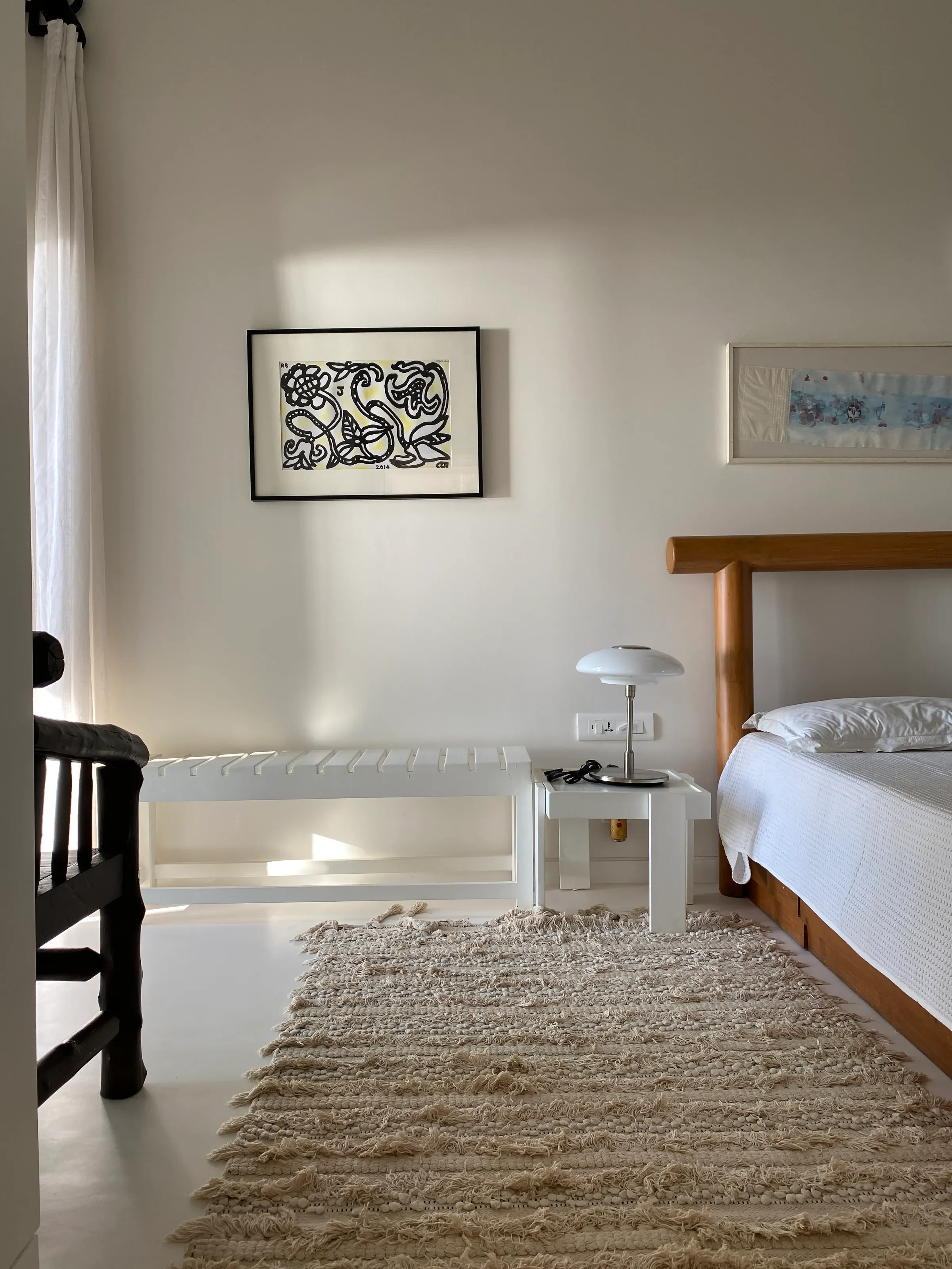 A bedroom in white and jute at the Marve beach house