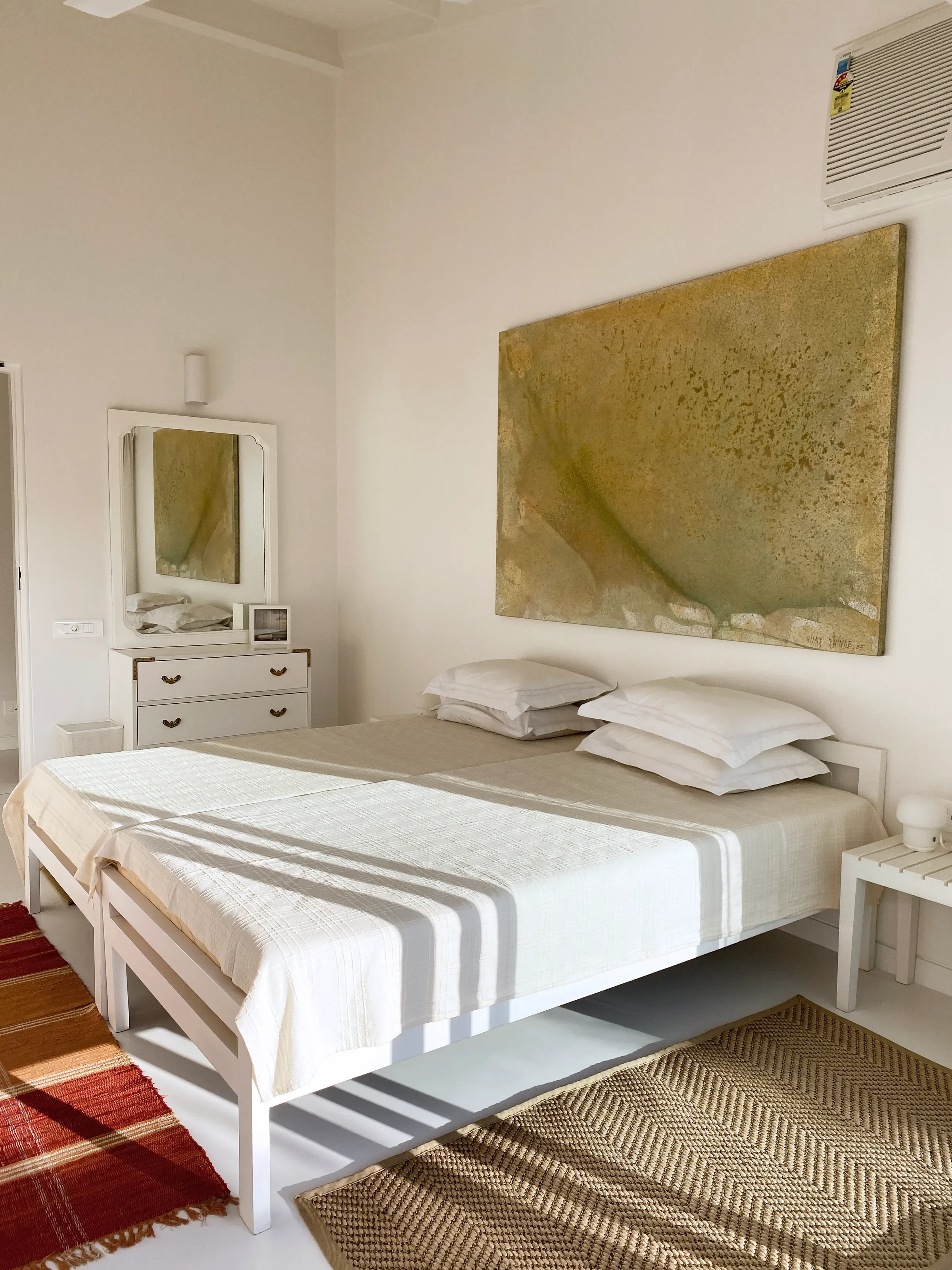 The white bedroom and its kilim runner at the Marve beach house