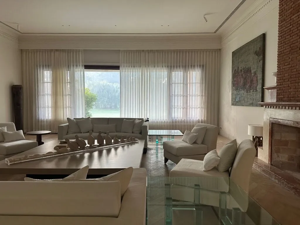 Sofas around the fireplace at the Delhi farmhouse