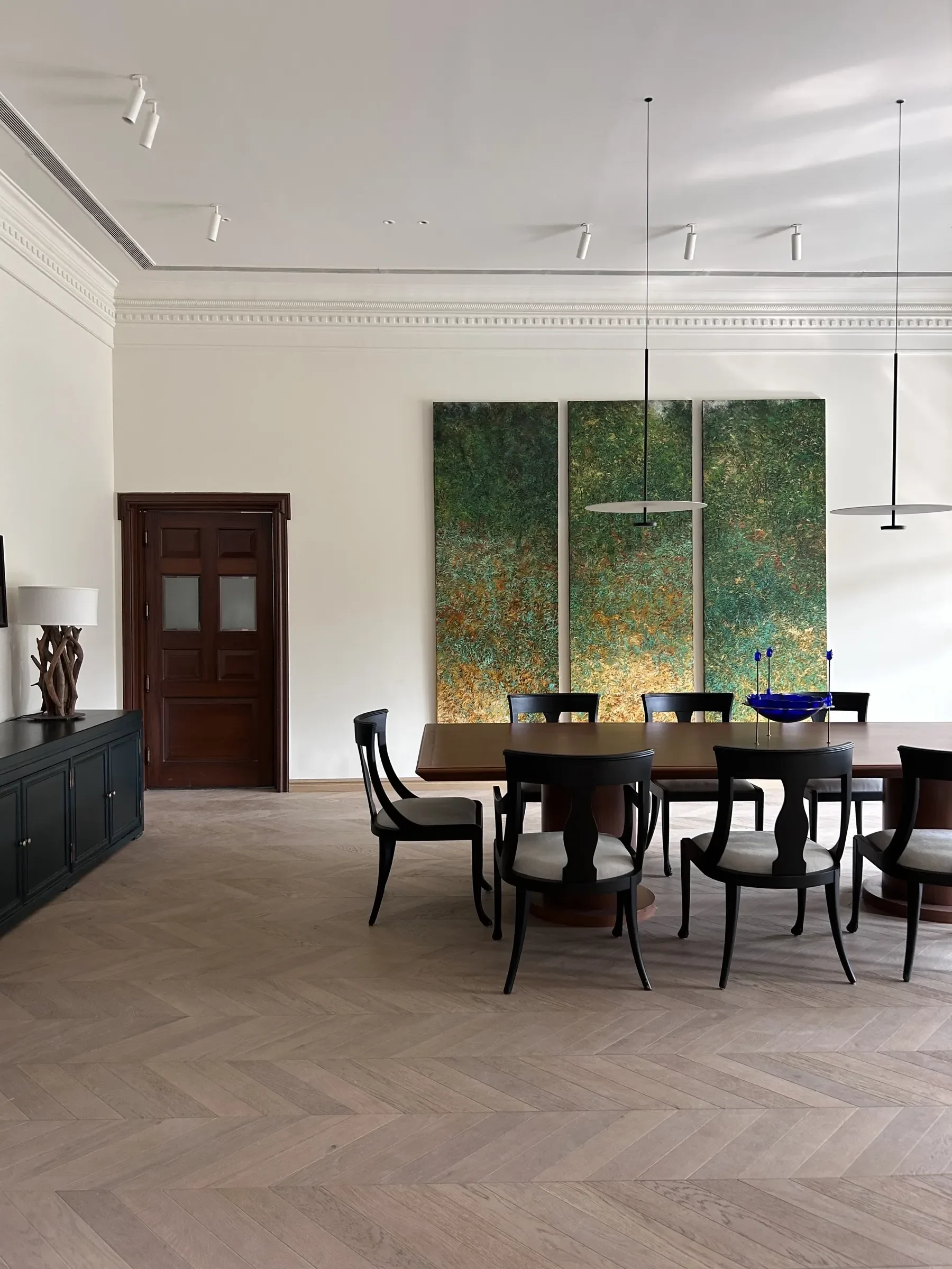 Dining room with green triptych art at the Delhi farmhouse