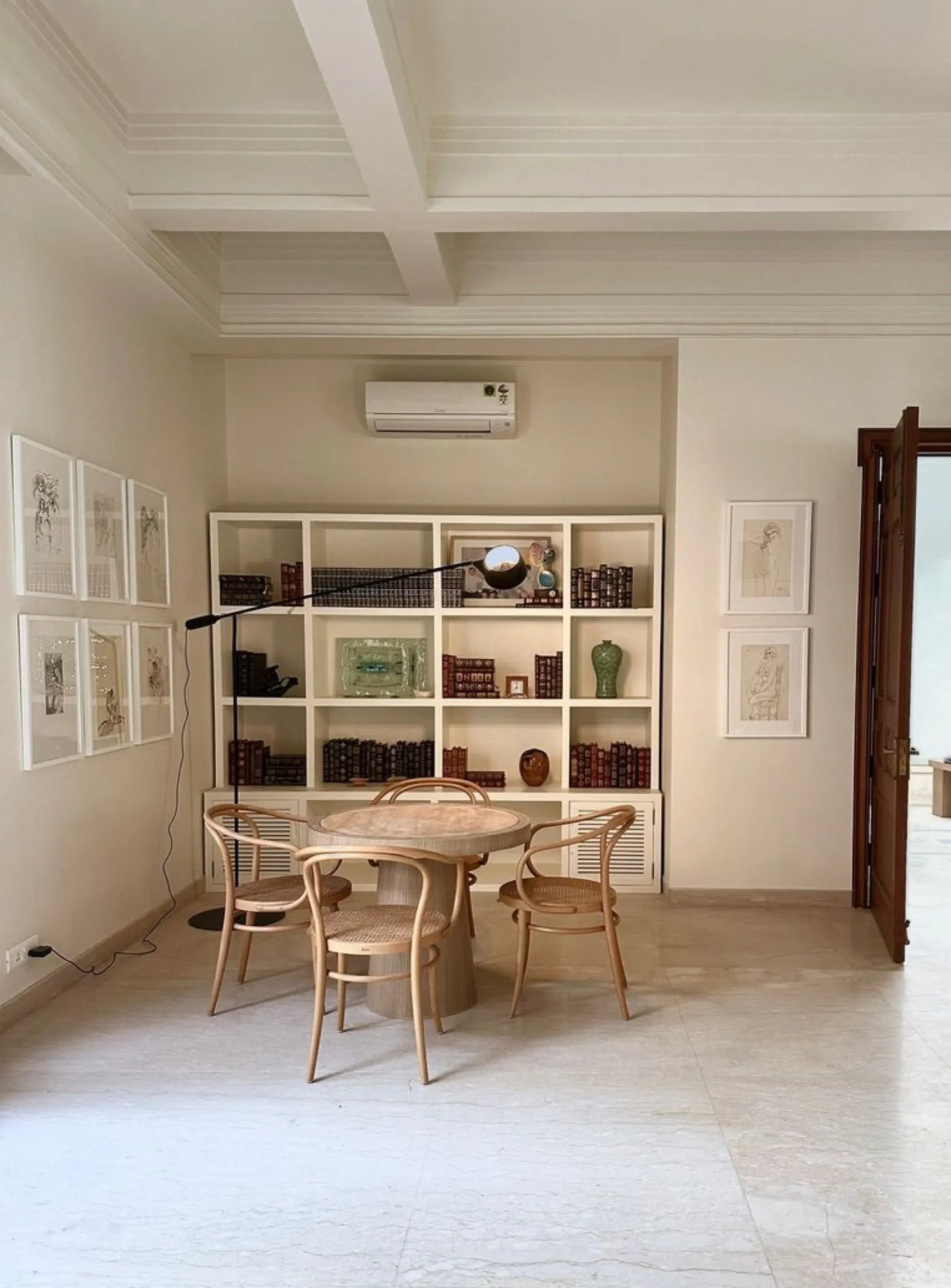 Study with bookshelf and round table at the Delhi farmhouse