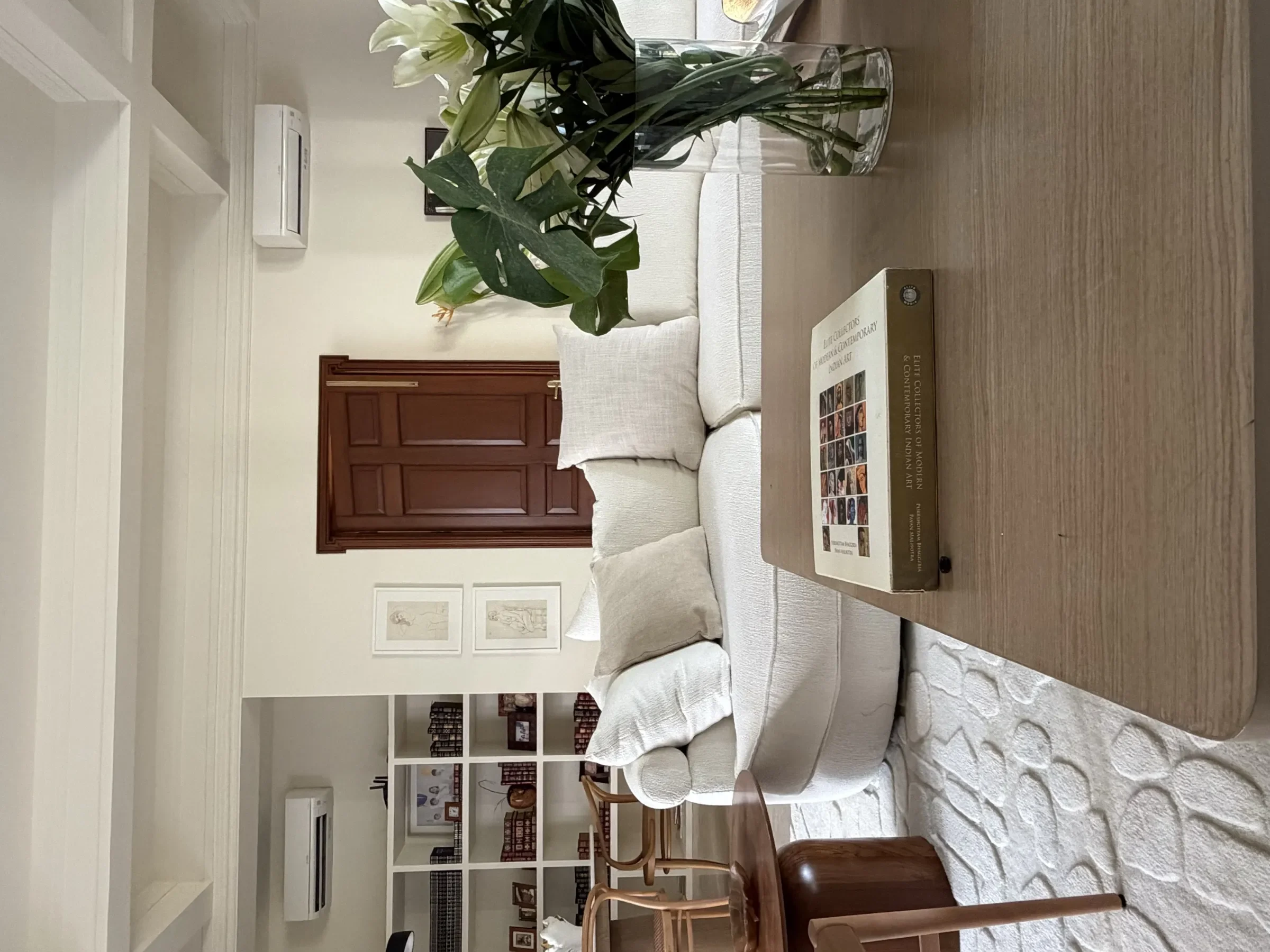 Living room seen through the brick-framed entrance at the Delhi farmhouse