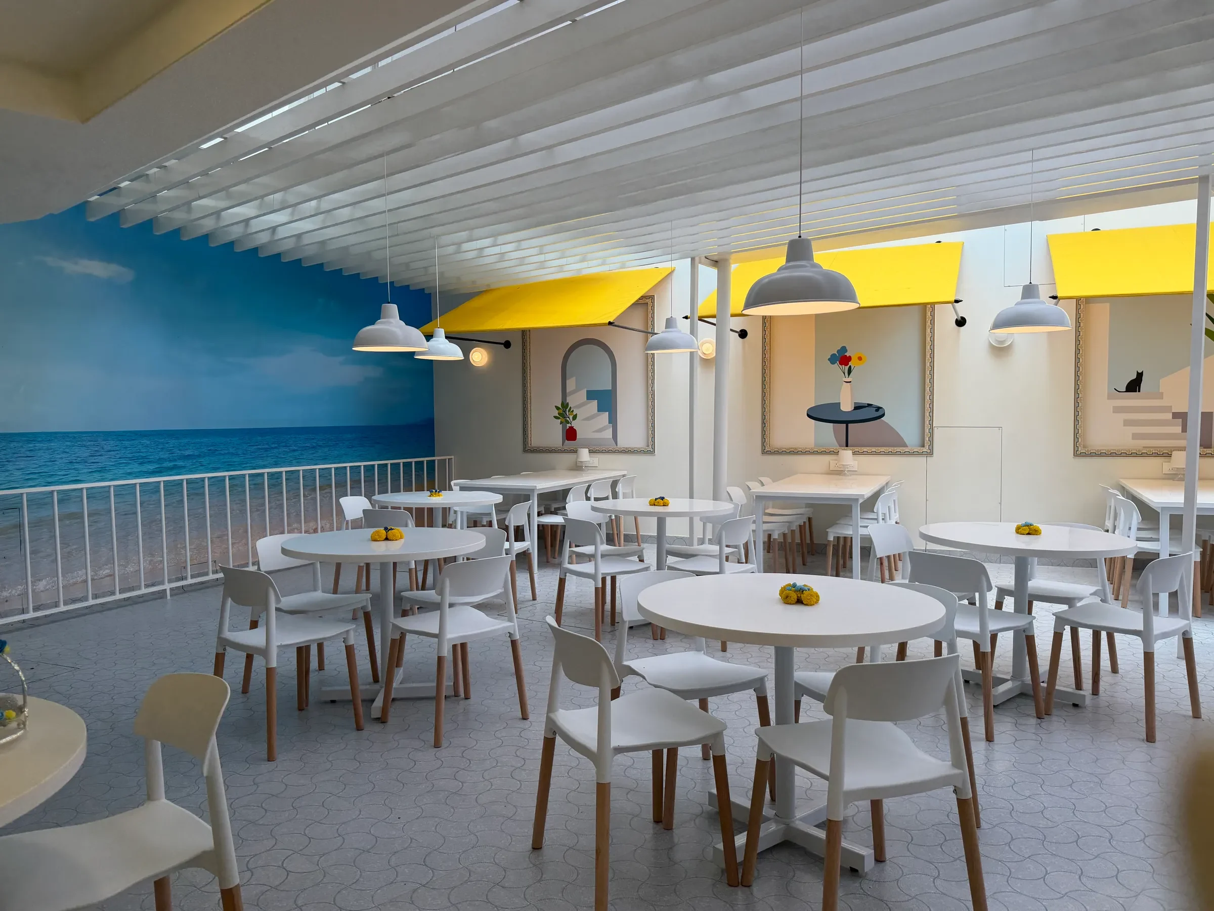The painted sea mural and yellow awnings at the Seagull Cafe