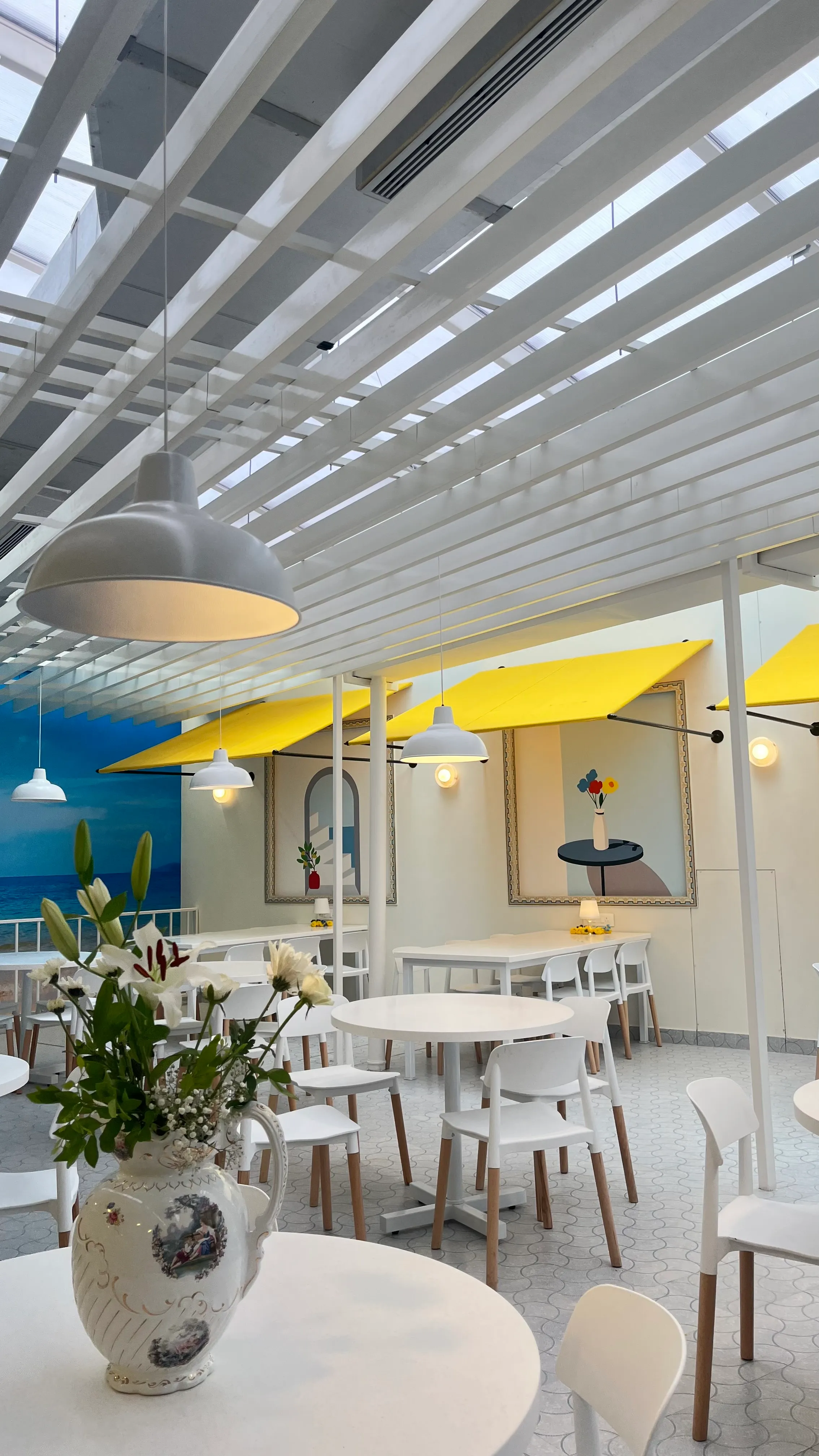 White tables under the slatted ceiling at the Seagull Cafe