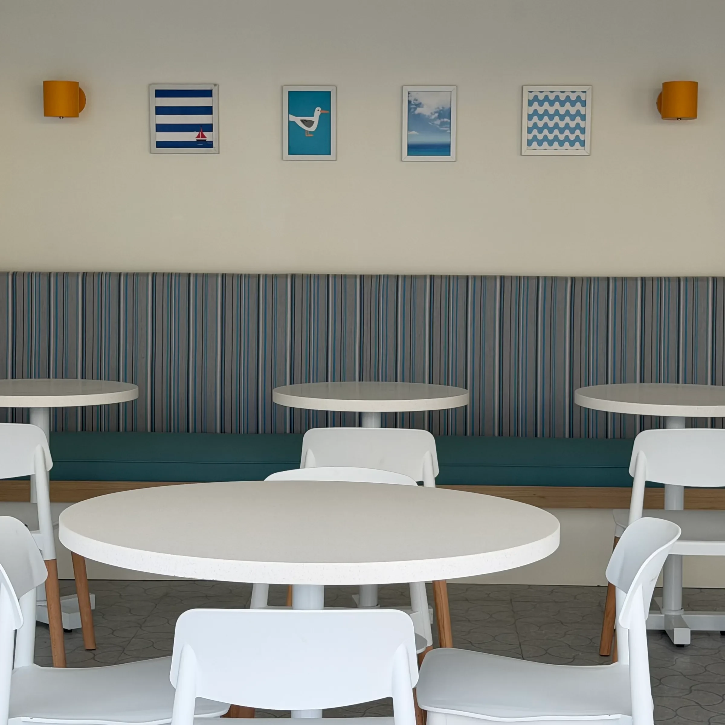 The striped banquette and framed prints at the Seagull Cafe