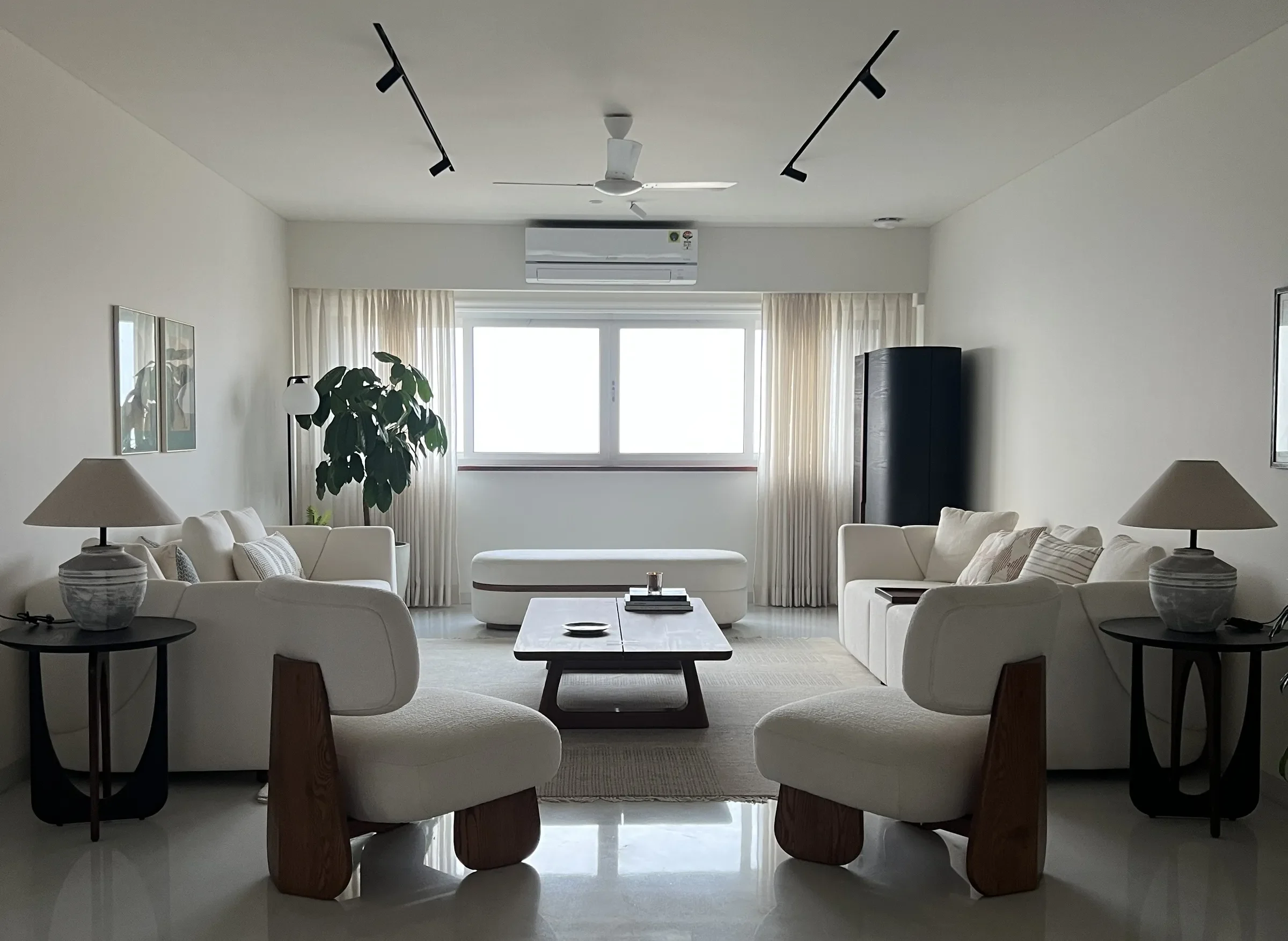 The living room and its curved sofas at the Sterling apartment