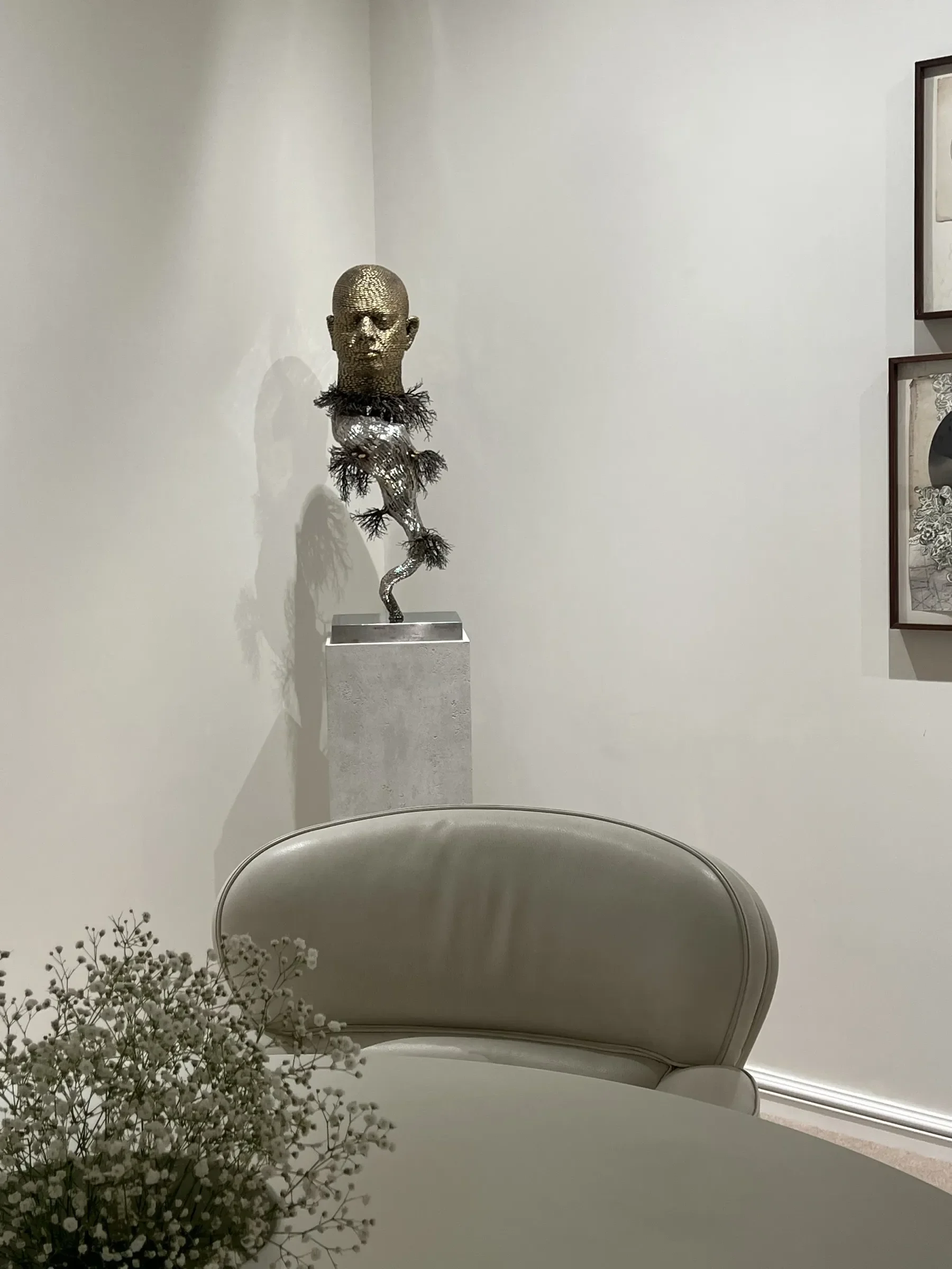 A bronze figure on a concrete pedestal at the RPG office