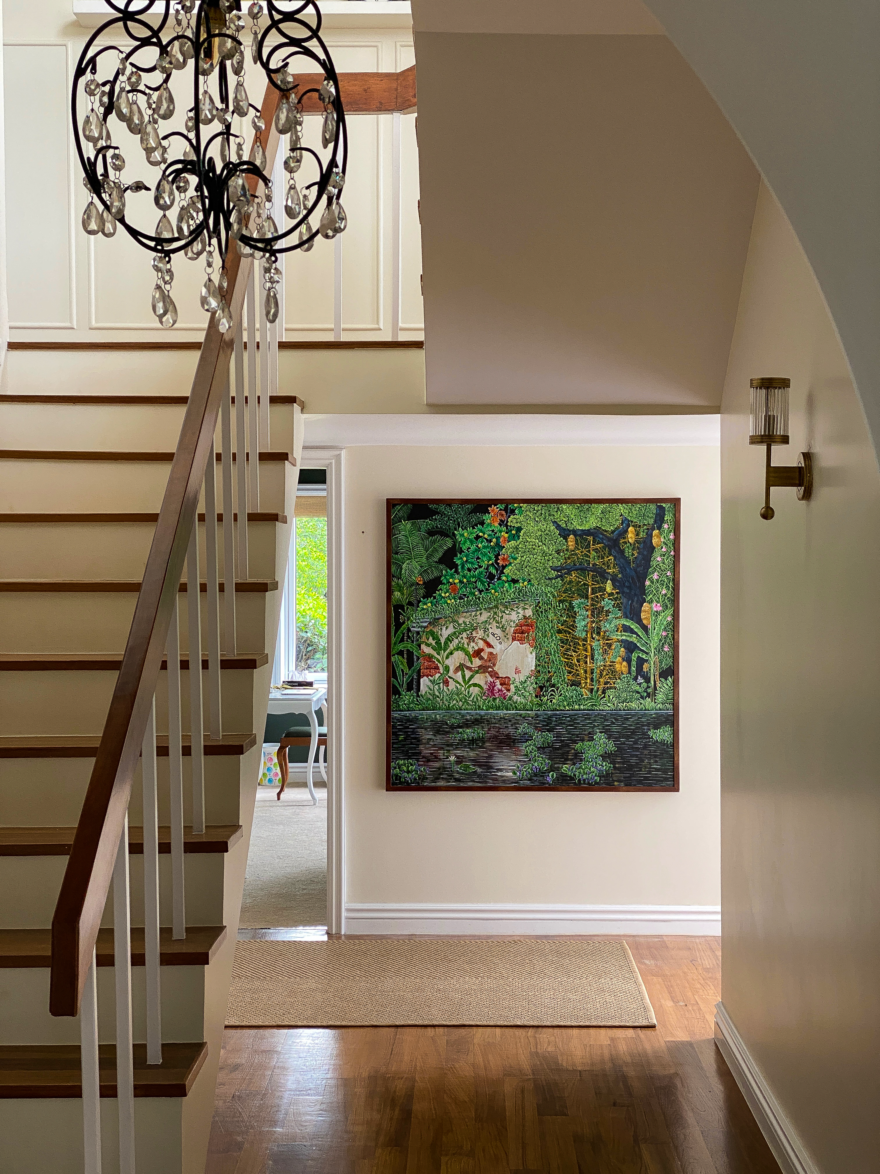 Staircase with chandelier and painting