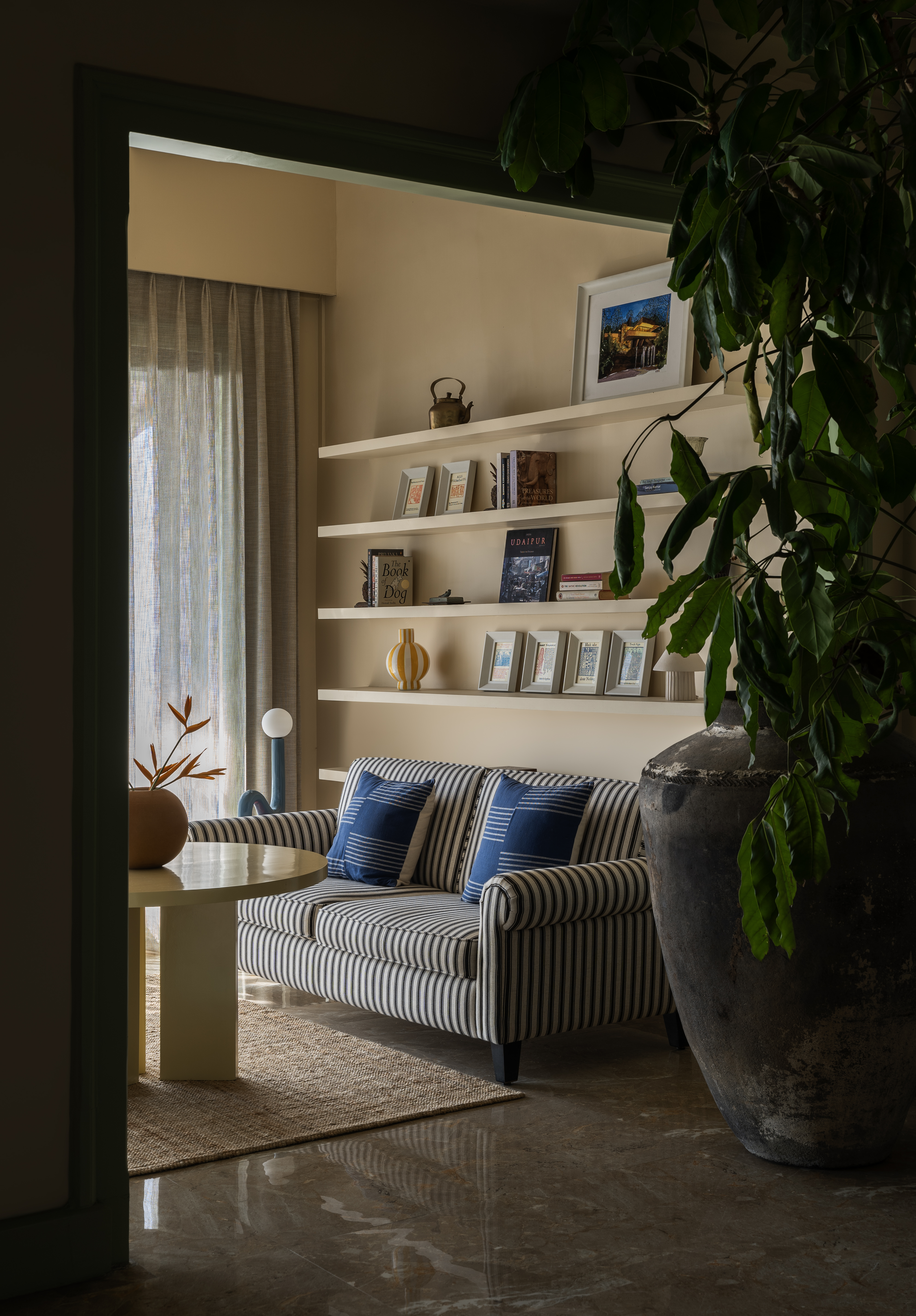 Library nook with blue-striped sofa