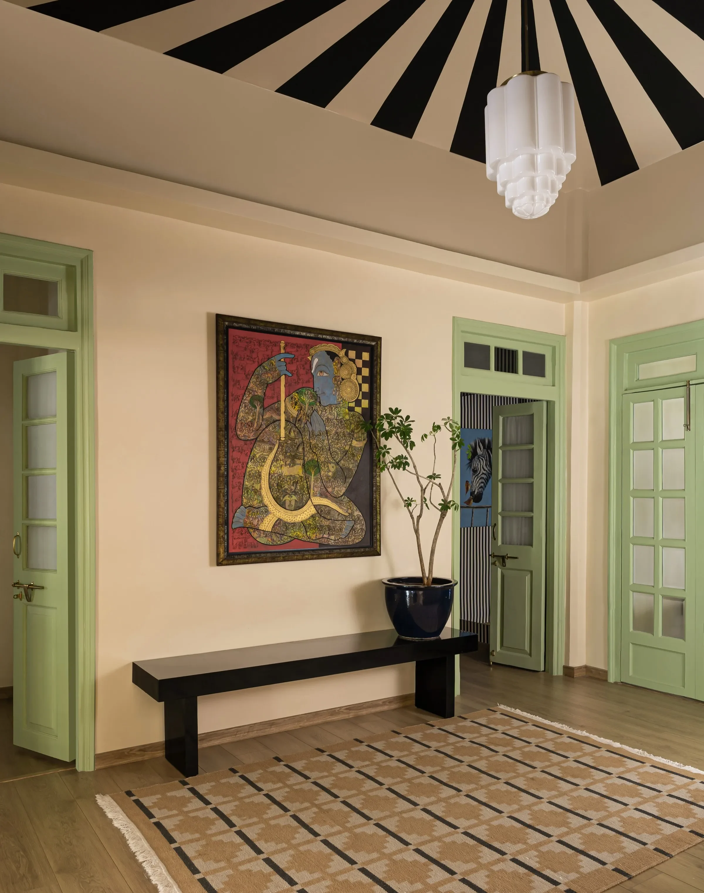 Entrance hall with painted ceiling, Pichwai art and green doors by Sonia Gehlot